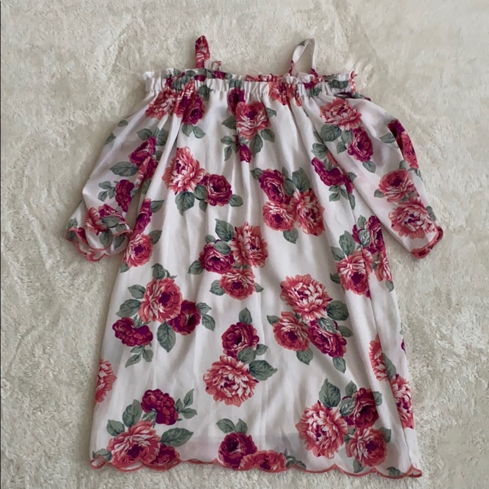 White dress with a pink floral design.